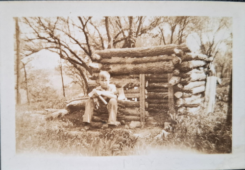 Dad-in-front-of-log-cabin.png